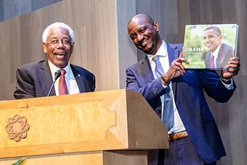 Former Santa Monica Mayor Nat Trives (left) presents a token of appreciation to keynote speaker Derric J. Johnson