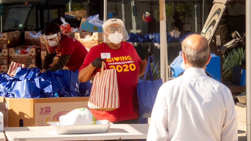 President Jeffery hands out Thanksgiving groceries